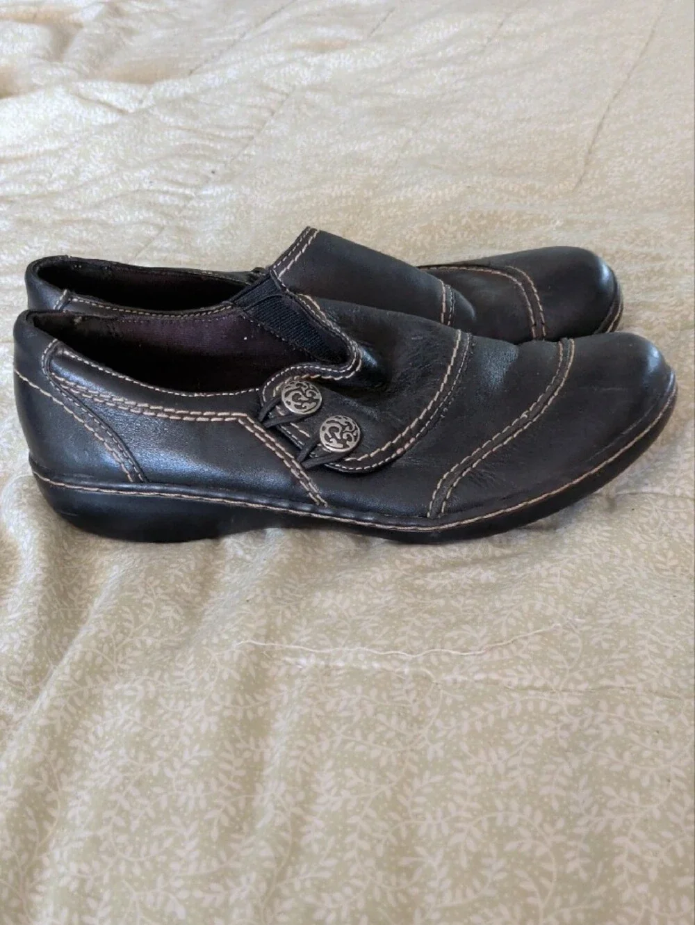 Clarks Black Slip-On Loafers with Silver Button Accent